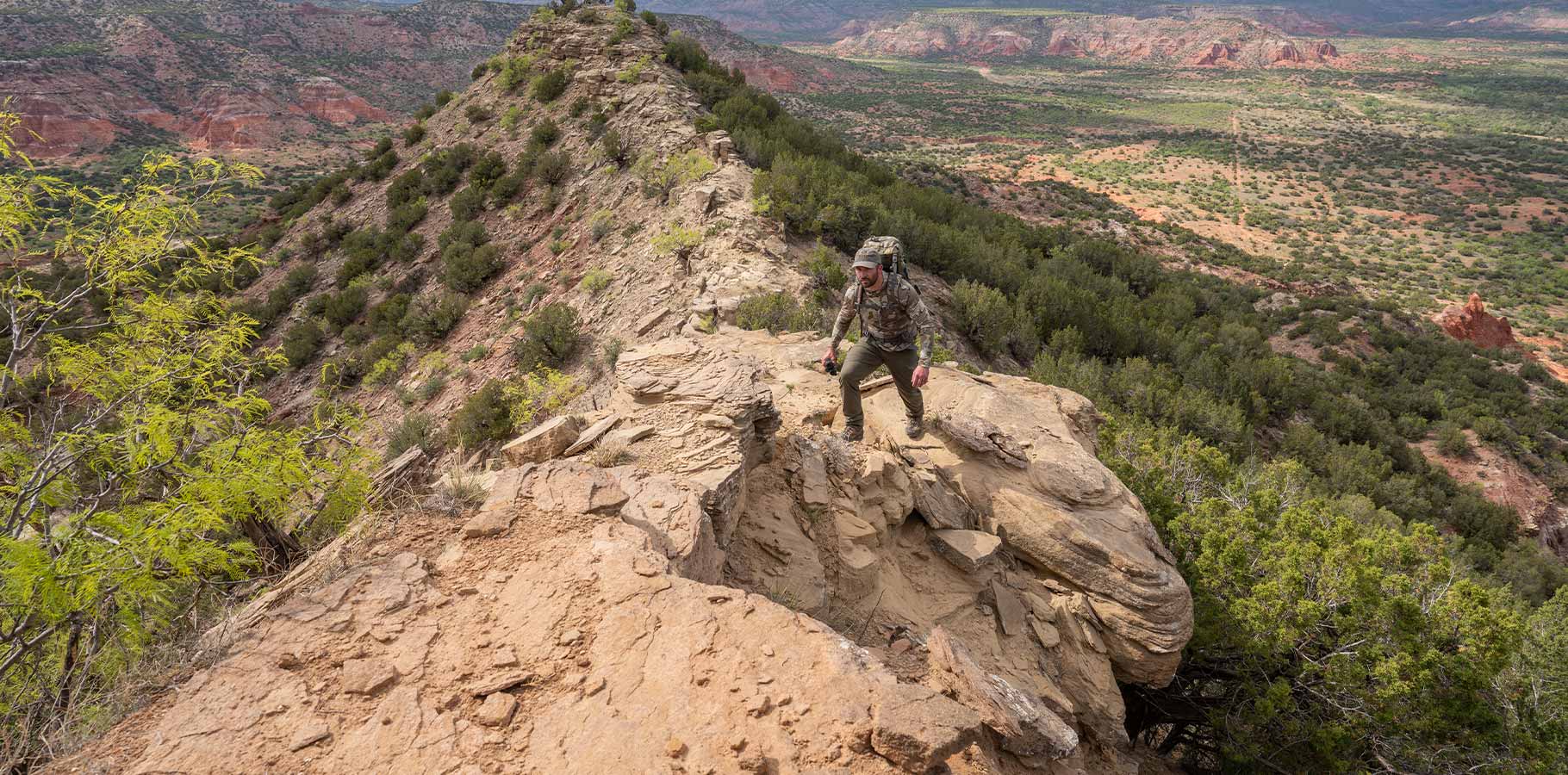 Front of Hunter in Valo Camouflage Hiking on Rocky Spine