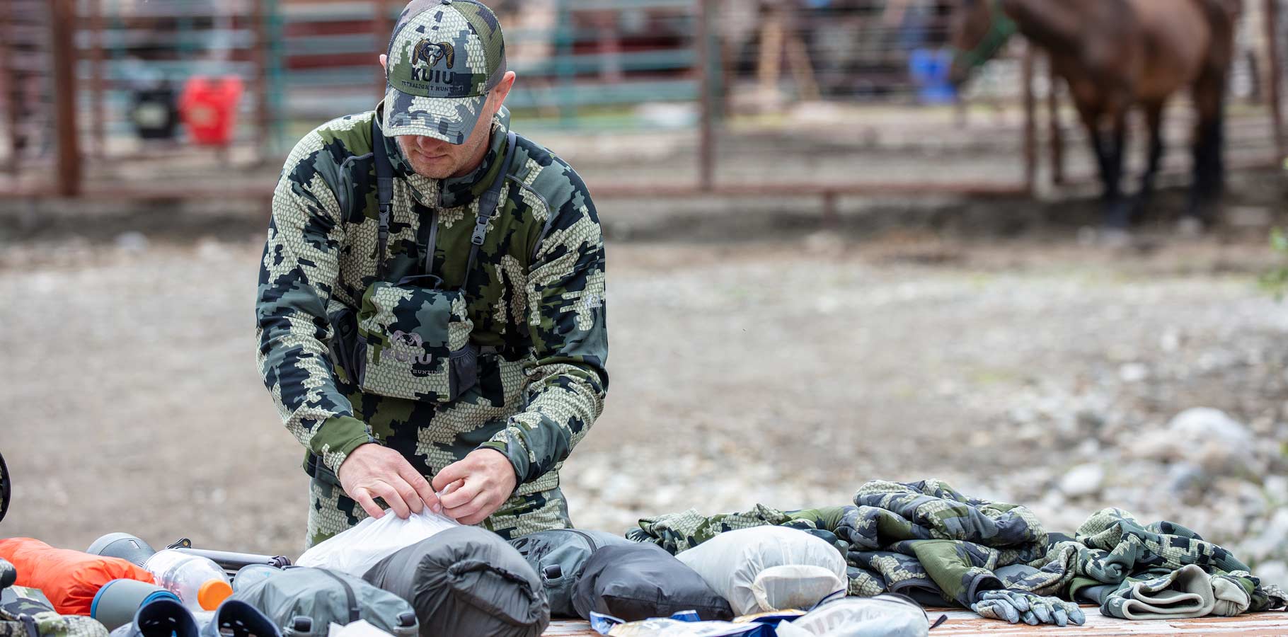 Front of Brendan Burns in Verde Camouflage Organizing Gear Before Hunt