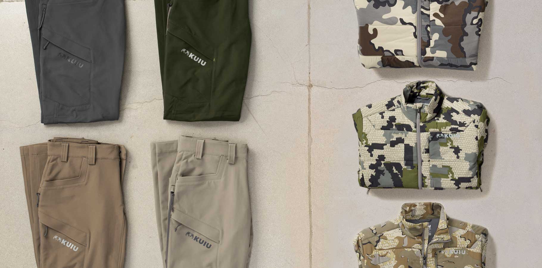 Garage floor image of folded and laid out gear list items showing solid colors and camo patterns