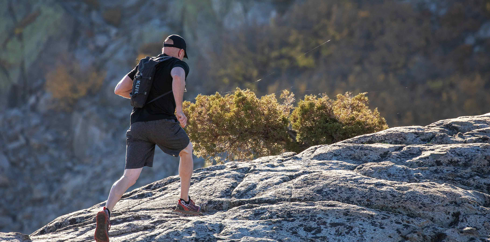 Back of Hunter Running On Ridge Wearing Stalker 500 Pro in Gunmetal Grey Color