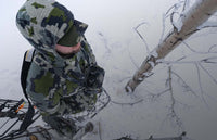 Top-down view of bowhunter in Verde camouflage standing in a treestand