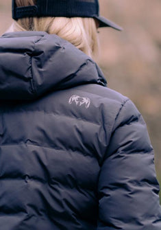 Back of female hunter wearing Women's Elements Hooded Jacket in Gunmetal Grey