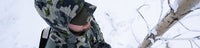 Bird's view of Hunter standing in a tree stand above the ground covered in snow