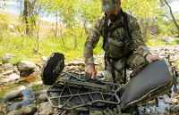 Hunter securing portable treestand in the KUIU Encounter Divide 2800 whitetail hunting day pack