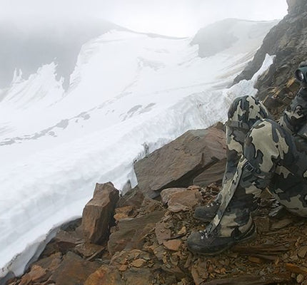 Front, Angled View of Hunter Glassing Game from Scree Covered Slope Wearing Vias Camouflage