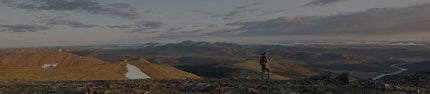 Back of Hunter Wearing Vias Camouflage Overlooking River and Valleys